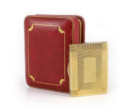 A 1930's Cartier 9ct gold compact, with diamond set thumbpiece,with reeded decoration and handled twin compartmental interior