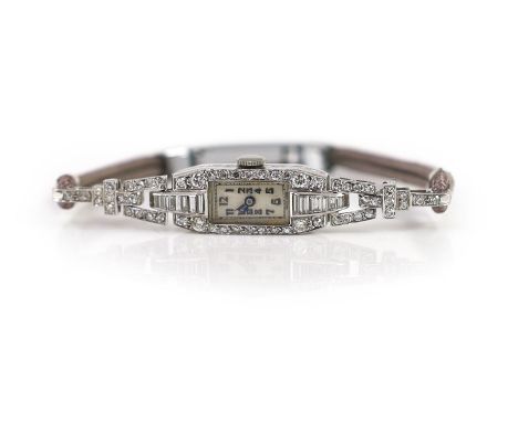 A lady's platinum, round and baguette cut diamond set rectangular manual wind cocktail watch,with on a steel and twin fabric 