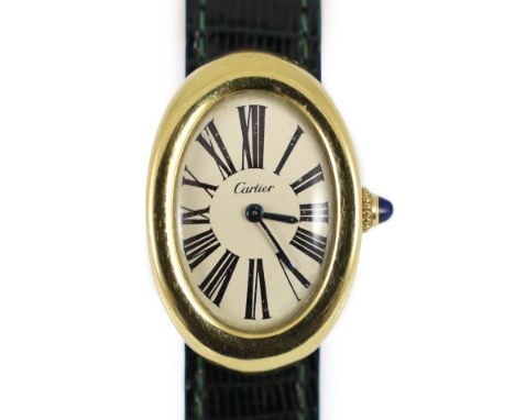 A lady's 18ct gold Cartier Baignoire manual wind oval wrist watch, on a Cartier green leather strap with deployment clasp,wit