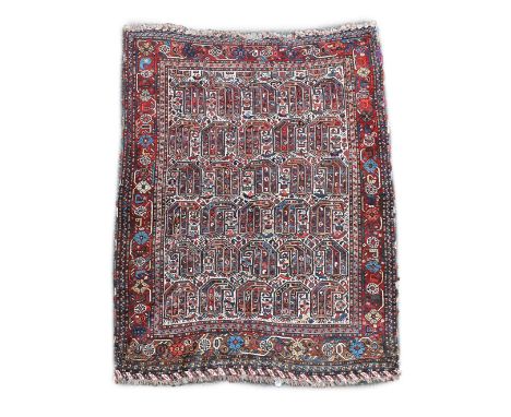 A Southern Persian ivory ground rug,woven with rows of hooked devices with a wide floral border175 x 137cmThe border has thre