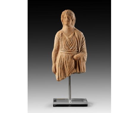 Jüngling mit Tunika und Mantel. Etruskisch, 4. - 3. Jh. v. Chr. H 29cm. Beige-rötlicher Ton. Versintert, oberhalb der Knie ge