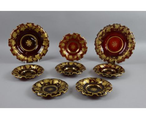 Set of six Bohemian ruby glass dishes with grapevine decoration and two others larger similar, the largest 21.5 cm diam. (8 t
