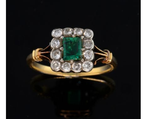 Diamond and emerald cluster ring, with rectangular step cut emerald  0f 0.30 carat within a border of small diamonds, unmarke