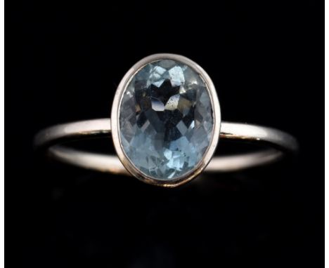 Aquamarine set ring in plain white gold rub-over setting  with oval faceted stone estimated at 1.00 carat  Good condition Rin