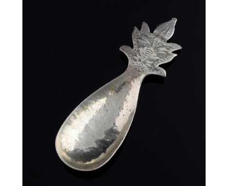 George V novelty silver caddy spoon of organic form, stern formed as carrot leaves with a hammered finish, by R C, London, 19