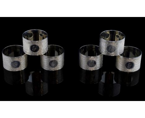 Set of six George V silver napkin rings with engine turned decoration, by Viner's Ltd., Sheffield, 1934, 9.9oz, 309g, 