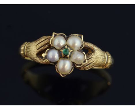 Pearl and emerald ring, with a gold hands to each shoulder mounted in gold. Ring size M Ring has been resized, some fine scra