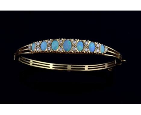 Opal and diamond bangle, set with oval cut opals and small diamonds, 9 ct  gold.  6 x 5.5 diameter   Gross weight 14.6 grams