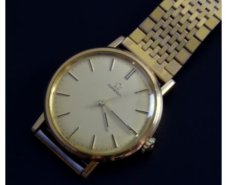 Omega Gentleman's gold plated watch, round champagne colour dial, manual winding movement on a gold plated bracelet. 34mm  