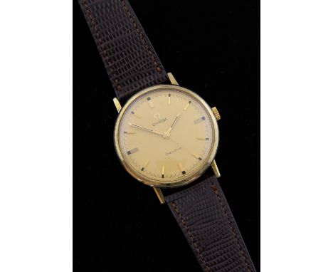 Omega Genève gold plated watch, round champagne colour dial, signed omega button, on a brown strap. Manual winding movement  
