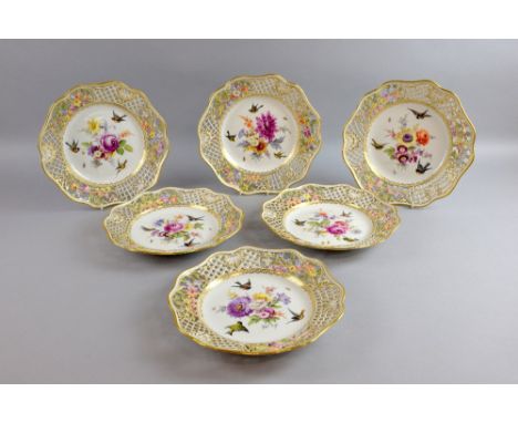 Six 19th Century Meissen porcelain cabinet plates with lattice pierced gilt decorated borders with hand painted floral sprays