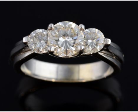 Three stone diamond ring, centre diamond weighing approximately 1 carat, two smaller diamonds approximately  0.35 carat in 18