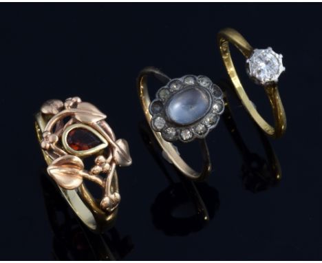 Single stone diamond ring, set in platinum and 18 ct gold, diamond estimated at 0.20 carat, ring size L a garnet ring in leaf