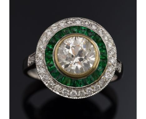 Emerald and diamond target ring, set with round brilliant cut diamond to the centre weighing approximately 1.30 carats with a