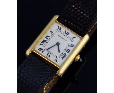 Cartier tank 18ct gold watch, rectangular white dial with black roman numerals, on a black Cartier strap with a 18ct gold buc