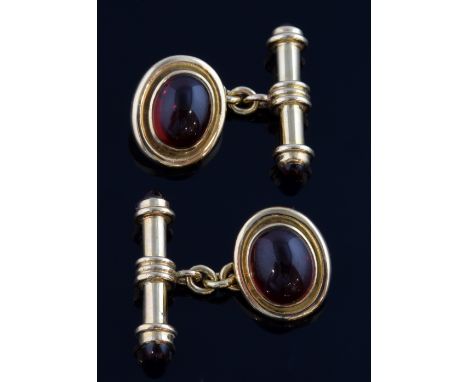 A pair of gold cufflinks, the fronts set with cabochon garnets, the bar ends also set with garnets, in 9ct gold   11.5 grams 