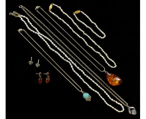 Two freshwater pearl necklaces, matching bracelet,  amber pendant and matching earrings, emerald and cats eye stone earrings,