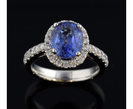 Sapphire and diamond dress ring, oval cut sapphire to the centre with a border of round brilliant cut diamonds, further diamo