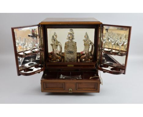 Early 20th century mahogany and marquetry inlaid decanter box, fitted with three decanters and glasses, 35cm x 27cm x 37cm hi