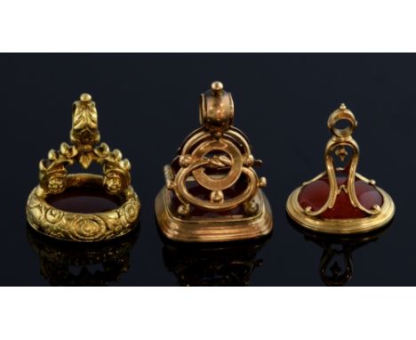 Gold fob intaglio  with figure of  a gentleman, another with Isle of Man insignia, and a heraldic seal, carnelian set in unma