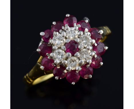 Ruby and diamond cluster ring, in 18 ct yellow and white gold, raised setting, ring size M 1/2  Good condition Gross weight  