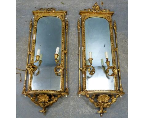 Pair of late 19th century gilt gesso, shelved, two light girandoles moulded with shells and foliage. 136cm high, 48cm wide, 2