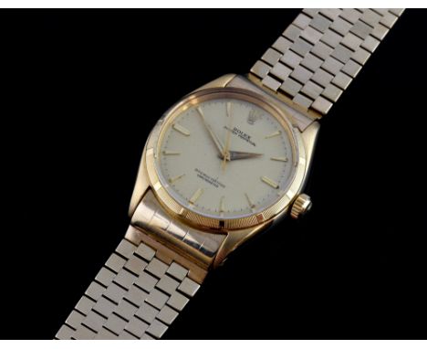 Rolex gentleman's Oyster Perpetual automatic watch, Ref 6565, champagne colour dial, 18ct gold case on a 9ct gold rolex brace