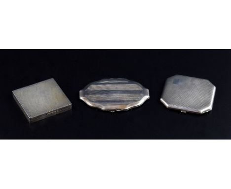 George VI silver square compact with engine turned decoration, Birmingham, 1947, and two others, all in cloth cases,  