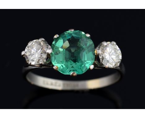 Vintage emerald and diamond ring, with central emerald estimated at approximately, 1.80 carats, the two diamonds weighing 0.4