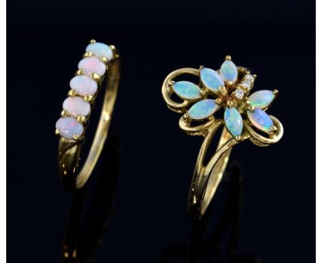 An opal cluster ring in floral design ring size U and an opal line ring, ring size V both 9 ct  Gross weight 4.9 grams