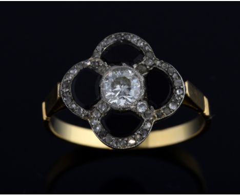 An Art Deco onyx and diamond cluster ring, in a four leaf clover shape with an old European cut diamond to the centre weighin