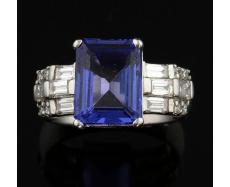 Tanzanite and diamond dress ring, the step cut tanzanite weighing approximately 4.50 carat with baguette and round brilliant 