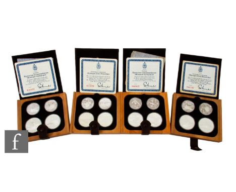 AMENDED DESCRIPTION Elizabeth II - Four Canadian Olympics 1976 ten and five dollar silver proof coin sets, 67g, each in a fau