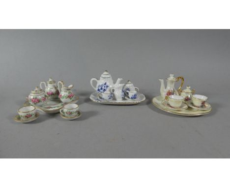 A Collection of Three Miniature Ceramic Tea Sets and Trays 
