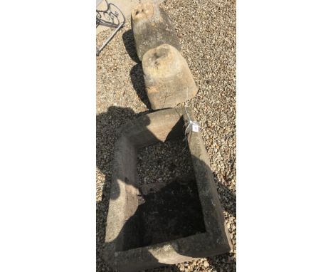 A large stone trough (half of base missing) and two large staddle stone bases