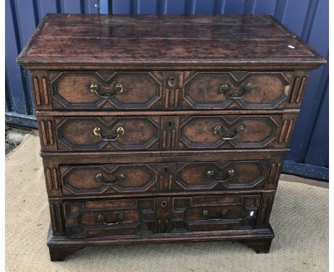 An oak chest in the Jacobean manner, the top with applied moulded edge over four long graduated drawers with applied moulding