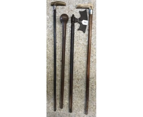 A 19th Century Indian Mughal warrior's rosewood handled iron axe, with shaped blade and engraved brass metal finial, approx 7