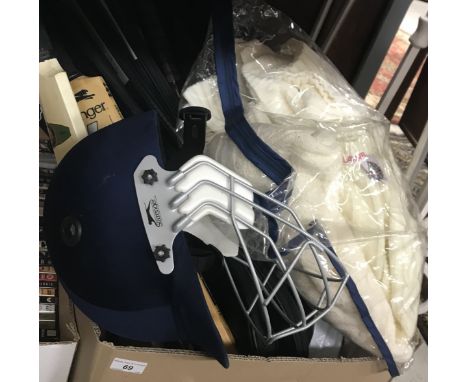 A box of assorted sporting equipment to include cricket bats, tennis rackets, cricket jumper, etc..CONDITION REPORTS PLEASE N