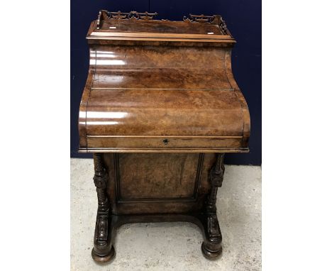 A Victorian burr walnut piano front Davenport with pop-up stationery compartment, the three quarter galleried top opening to 