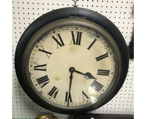 A Victorian circular wall dial/clock, the ebonised case enclosing a painted face with Roman numerals inscribed "Made in Engla