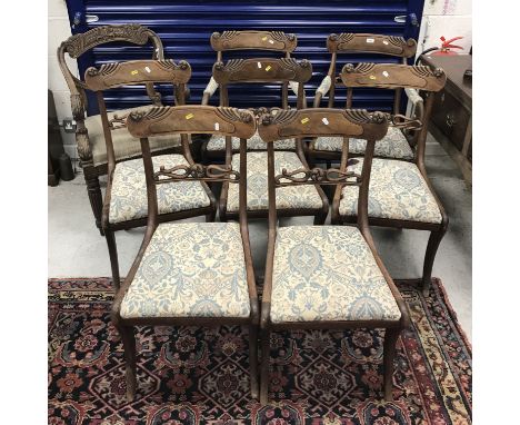 A set of seven (5 plus 2 carvers) William IV mahogany dining chairs, the carved bar backs over a scrollwork decorated back ra