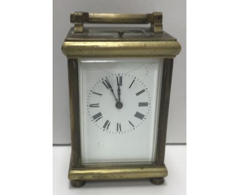 A circa 1900 brass cased carriage clock, the movement with repeat and white enamel dial with Roman numerals, numbered to back