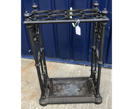 A Victorian cast iron eight section stick stand on scrollwork decorated reeded columns to an egg and dart decorated canted ba