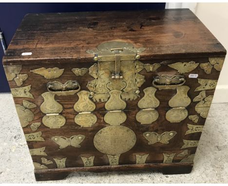 A 19th Century Chinese elm and pine brass bound marriage chest, the brass work with engraved Yin and Yang and other motifs, o