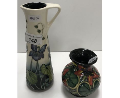 A Moorcroft "Dog Violet" pattern cream and blue ground jug of tapered form by Nicola Slaney, date marked for "2010", signed a