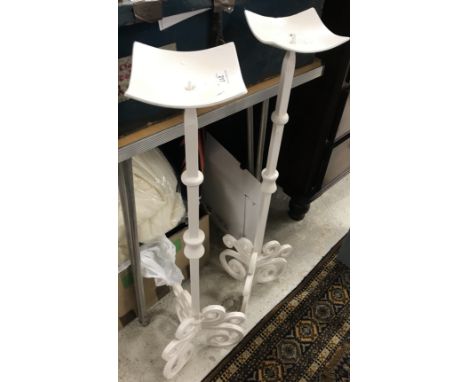 A pair of modern white painted wrought iron floor standing pricket candlesticks in the Arts & Crafts taste raised on scrollin