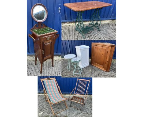 An Edwardian mahogany washstand with tile top over drawer and fielded panel cupboard door, a late Victorian wrought iron sewi