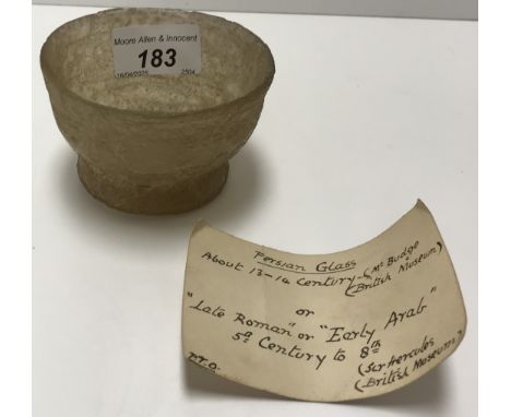 A late Roman glass beaker of inverted bell form raised on a circular foot, 8.7 cm diameter x 5.5 cm high together with old ha