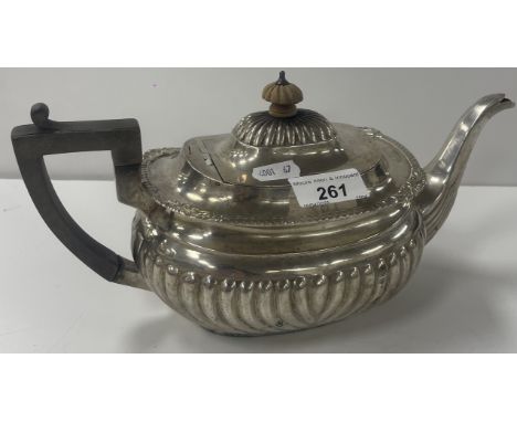 An Edwardian silver teapot with gadrooned decoration, ebonised handle and wooden finial (by Thomas Hayes, Birmingham 1900), 2