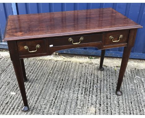 An early 19th Century mahogany side table with three frieze drawers, on turned tapering legs to pad feet, 106 cm wide x 56 cm